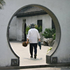Circular archway framing man walking in China