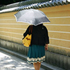 Japanese woman, yellow wall, contrast